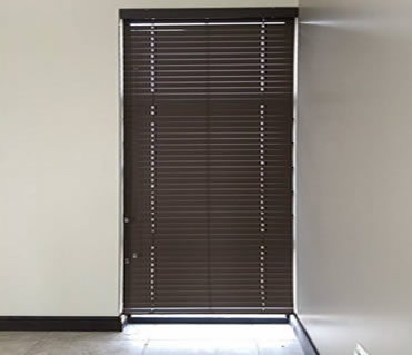 A brown matte finish 50 mm Venetian- blind on a living room window
