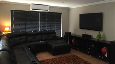 The Eco-Wood Emboya colour blinds compliment the dark look of this living room in a classy way.