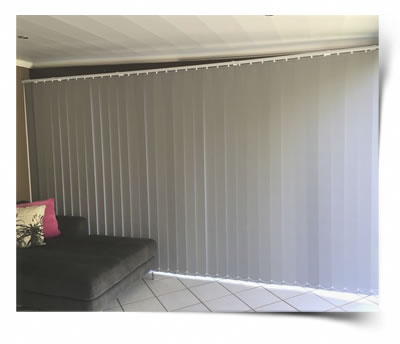 A Vertical blind close and slid to fill the whole sliding door